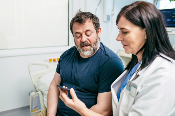Physician showing patient information on a mobile device
